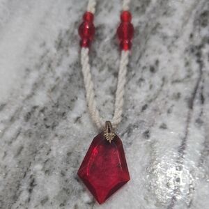 Antique early 1900's necklace with a candy red faceted shield glass pendant. 16"